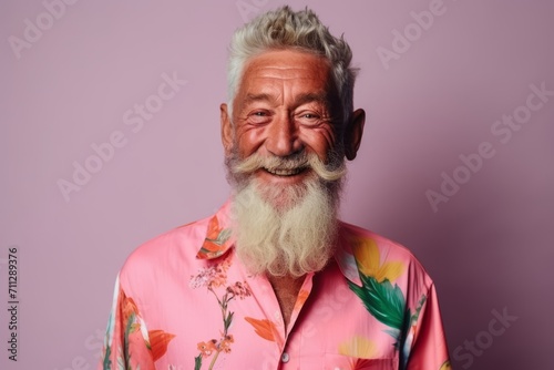 Portrait of an old man with a long white beard and a colorful shirt on a purple background