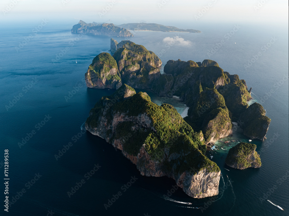Stunning aerial view of Ko Phi Phi Lee, a ring of steep limestone hills surrounding Maya Bay with Phi Phi Don in the distance. Phi Phi Islands, Andaman Sea, Krabi, Thailand.
