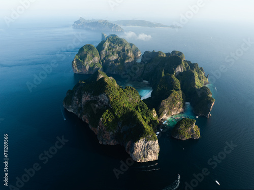 Stunning aerial view of Ko Phi Phi Lee, a ring of steep limestone hills surrounding Maya Bay with Phi Phi Don in the distance. Phi Phi Islands, Andaman Sea, Krabi, Thailand.