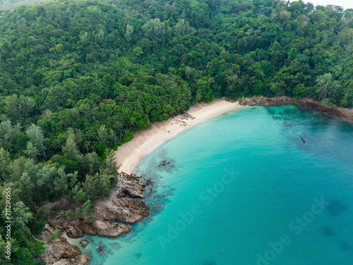 View from above, stunning aerial view of Banana beach, a beautiful white sand beach surrounded by palm trees and bathed by a turquoise water. Phuket, Thailand. © Travel Wild