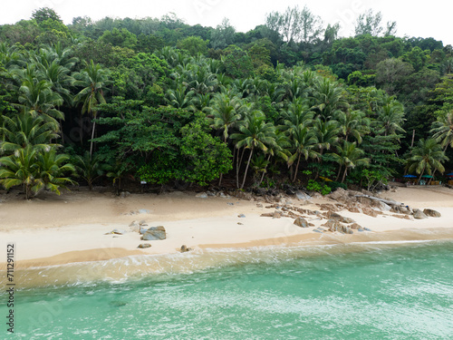 Obraz na płótnie View from above, stunning aerial view of Banana beach, a beautiful white sand beach surrounded by palm trees and bathed by a turquoise water. Phuket, Thailand. w salonie
