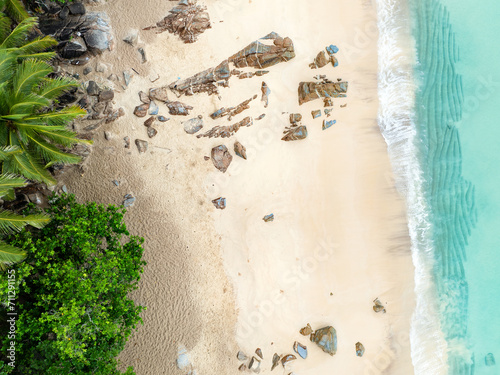 Obraz na płótnie View from above, stunning aerial view of Banana beach, a beautiful white sand beach surrounded by palm trees and bathed by a turquoise water. Phuket, Thailand. w salonie