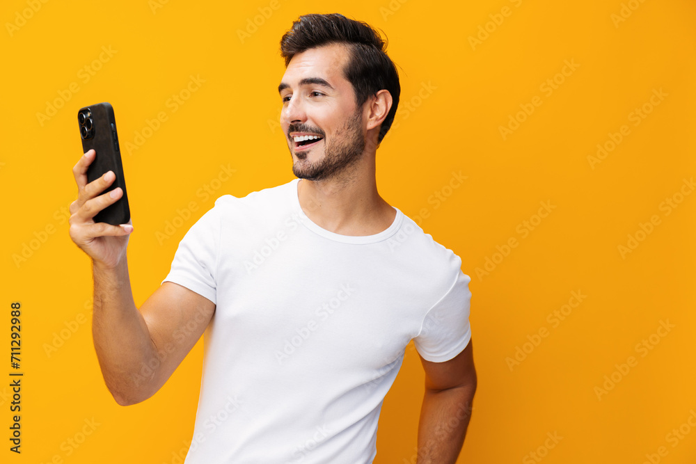 Smiling man studio smartphone yellow portrait technology phone space communication phone copy cyberspace happy mobile Smiling man studio smartphone yellow portrait technology phone space communication phone copy cyberspace happy mobile