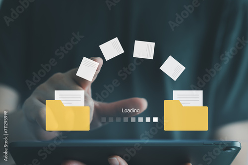 Hand touch on document for send file between folder on internet. Data migration, Data transfer, Backup data, Exchange of file on folder, DMS. Virtual document loading to another folder. photo