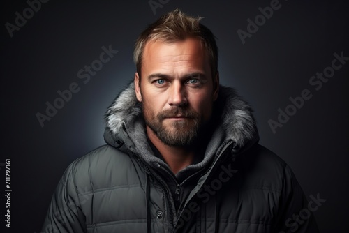 Portrait of a handsome man in a winter jacket. Men's beauty, fashion.