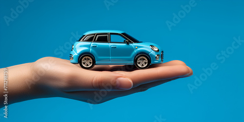    Businessman hand cover or protection  blue car toy on hands Concept of car purchase and insurance with toy car 
     photo