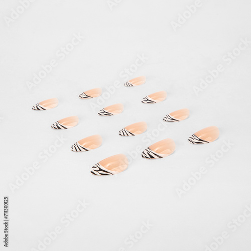 realistic set of colored false nails adhesive isolated on white background. top view. false nails acrylic nails for women. different fashion nail shapes.