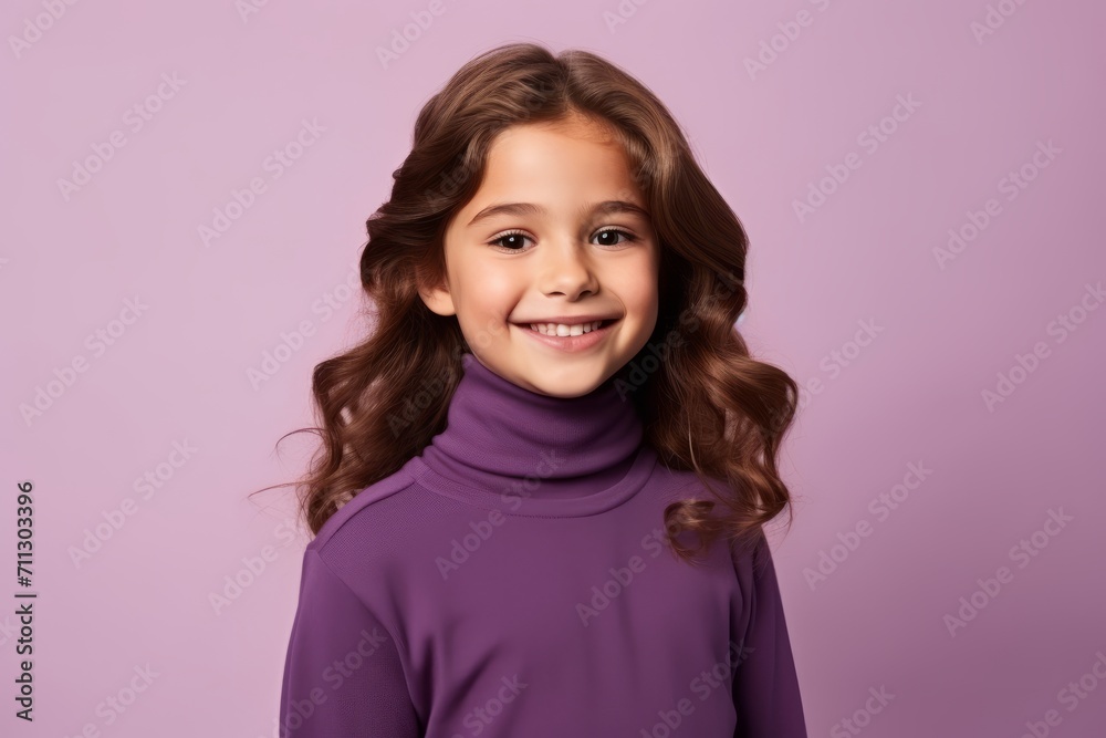 Portrait of a smiling little girl in a purple sweater on a purple background Portrait of a smiling little girl in a purple sweater on a purple background