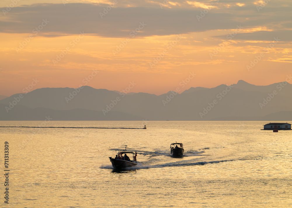 Naklejka premium fishing boat silhouette at sunset