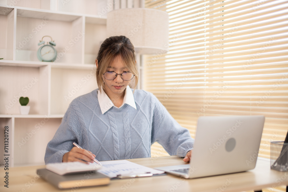 Woman analyzes data graphs, Works intently in his personal office, Employees working in the office, Businesswoman working in front of laptop. Woman analyzes data graphs, Works intently in his personal office, Employees working in the office, Businesswoman working in front of laptop.