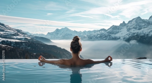 woman in hot tub meditating with mountains in background photo