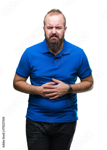 Young caucasian hipster man wearing blue shirt over isolated background with hand on stomach because indigestion, painful illness feeling unwell. Ache concept.