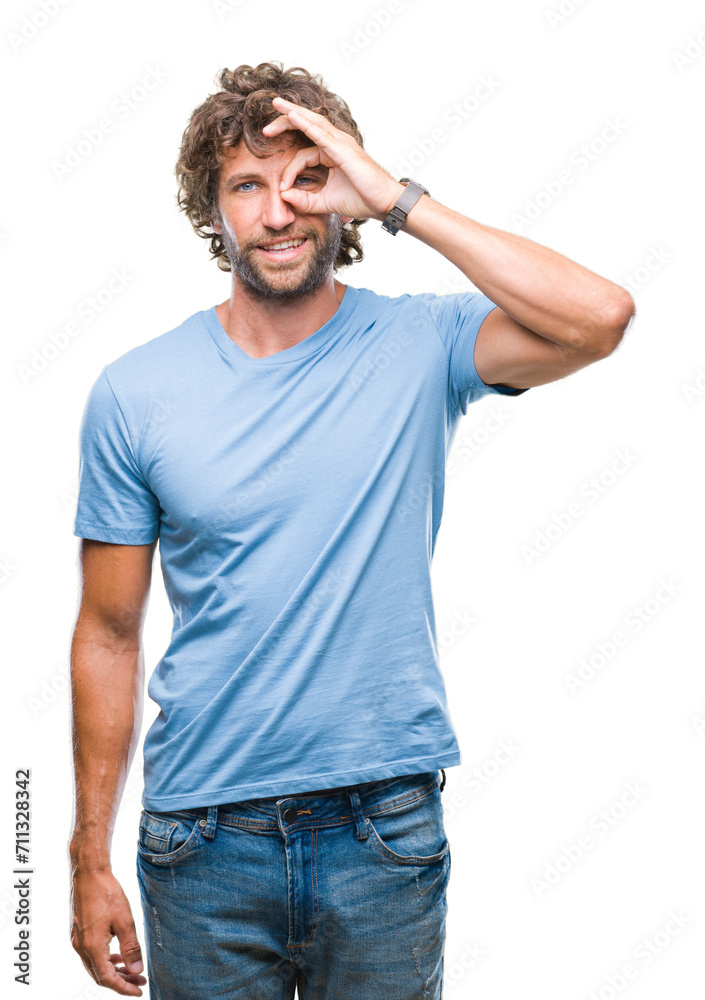Handsome hispanic model man over isolated background doing ok gesture with hand smiling, eye looking through fingers with happy face. Handsome hispanic model man over isolated background doing ok gesture with hand smiling, eye looking through fingers with happy face.