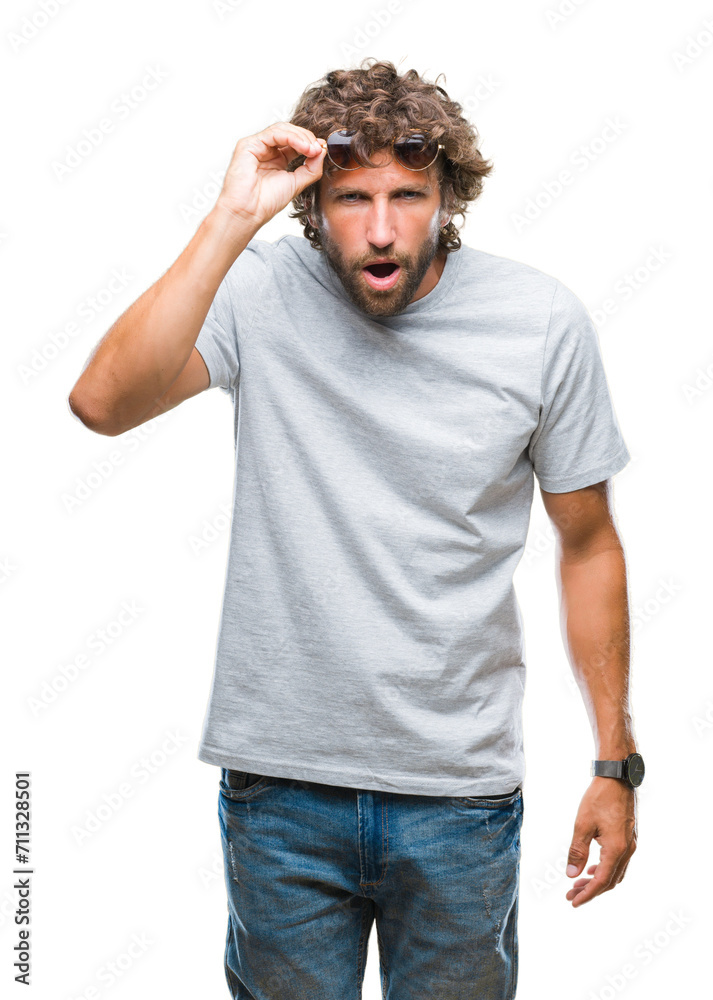 Handsome hispanic model man wearing sunglasses over isolated background afraid and shocked with surprise expression, fear and excited face. Handsome hispanic model man wearing sunglasses over isolated background afraid and shocked with surprise expression, fear and excited face.