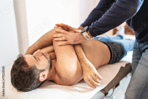Physical Therapist Performing Arm Adjustment photo