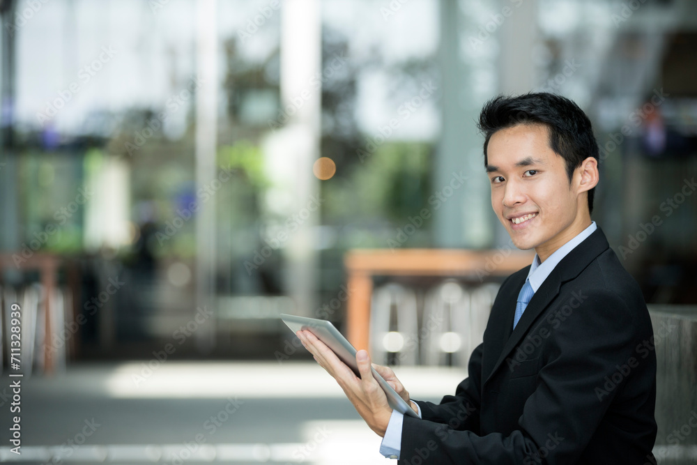 Chinese man with a tablet computer.