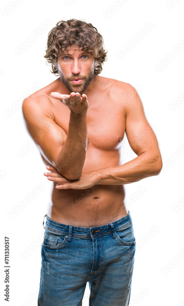 Handsome hispanic model man sexy and shirtless over isolated background looking at the camera blowing a kiss with hand on air being lovely and sexy. Love expression. Handsome hispanic model man sexy and shirtless over isolated background looking at the camera blowing a kiss with hand on air being lovely and sexy. Love expression.