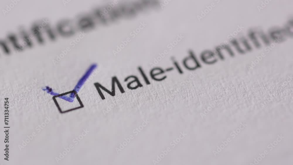 Marking Male-Identified on a Document. Extremely Close-up, shallow dof. Marking Male-Identified on a Document. Extremely Close-up, shallow dof.