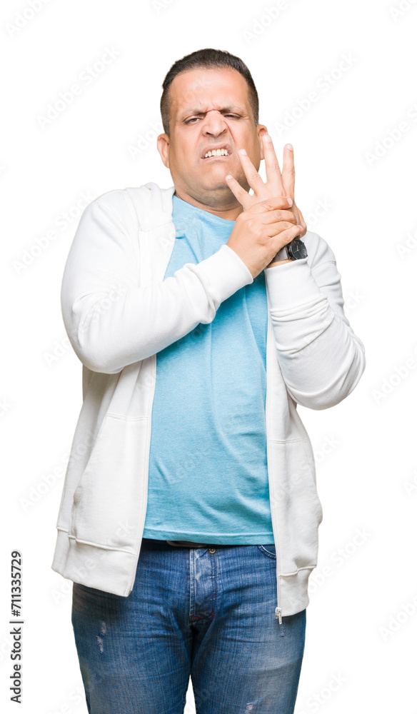 Middle age arab man wearing sweatshirt over isolated background Suffering pain on hands and fingers, arthritis inflammation Middle age arab man wearing sweatshirt over isolated background Suffering pain on hands and fingers, arthritis inflammation