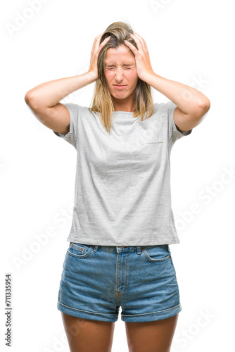 Young beautiful woman over isolated background suffering from headache desperate and stressed because pain and migraine. Hands on head.