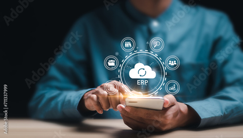 Cloud ERP, Enterprise Resource Planning concept. Businessman connecting data with cloud computing to access to HR management. Business resources plan to manage company enterprise resource. photo