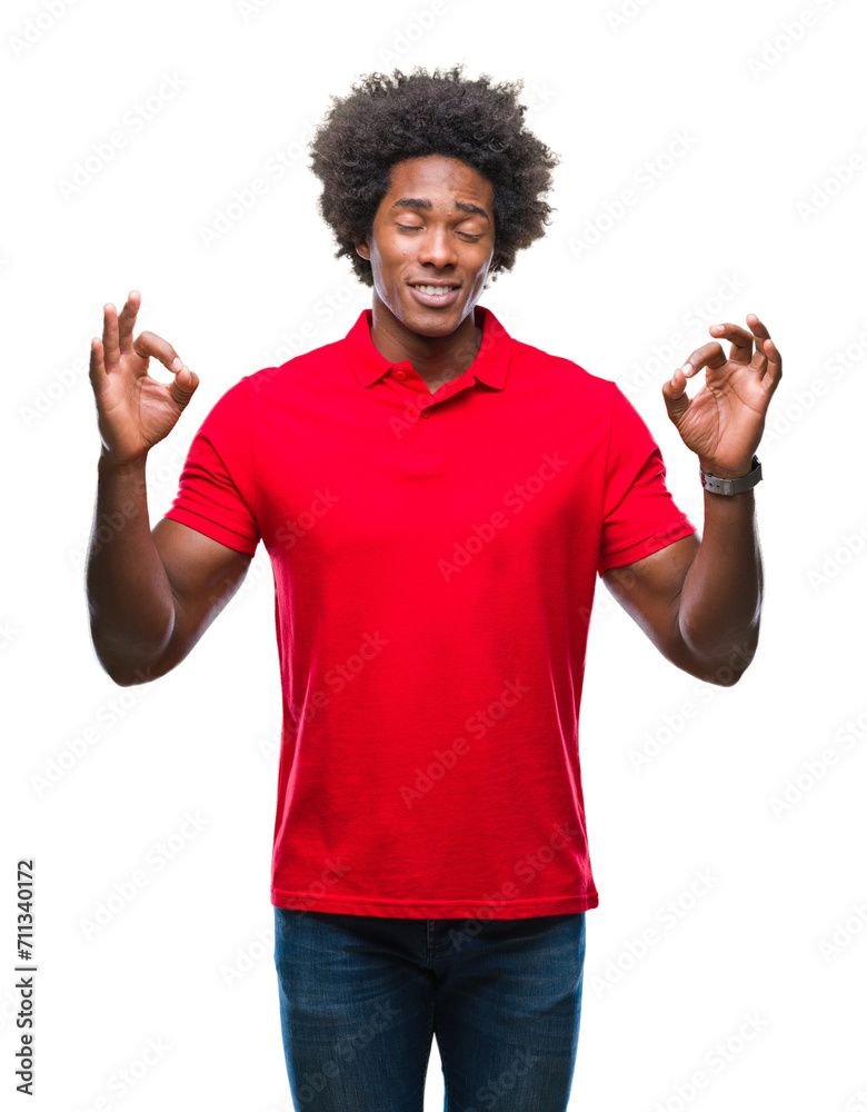 Afro american man over isolated background relax and smiling with eyes closed doing meditation gesture with fingers. Yoga concept. Afro american man over isolated background relax and smiling with eyes closed doing meditation gesture with fingers. Yoga concept.