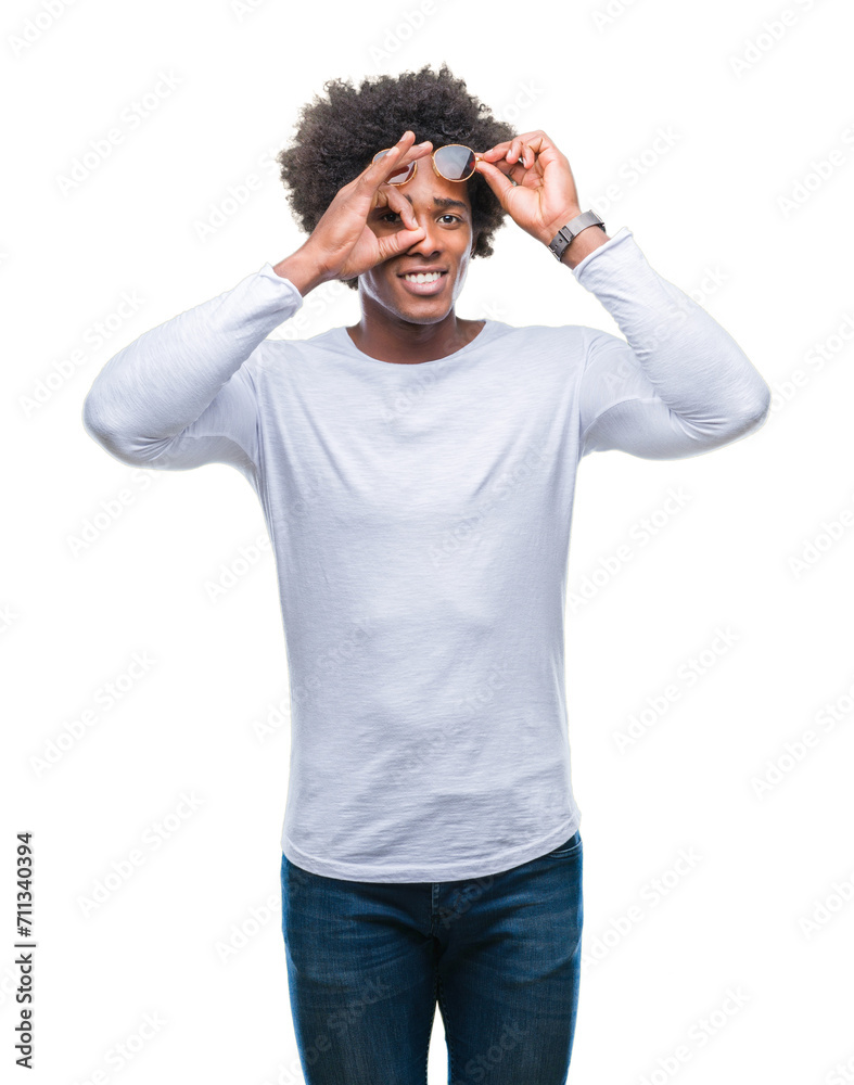 Afro american man wearing sunglasses over isolated background doing ok gesture with hand smiling, eye looking through fingers with happy face.