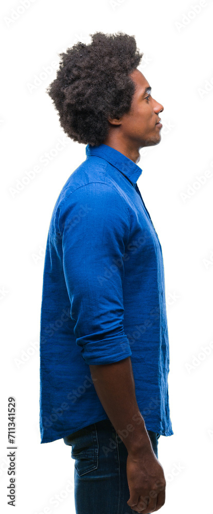Afro american man over isolated background looking to side, relax profile pose with natural face with confident smile. Afro american man over isolated background looking to side, relax profile pose with natural face with confident smile.