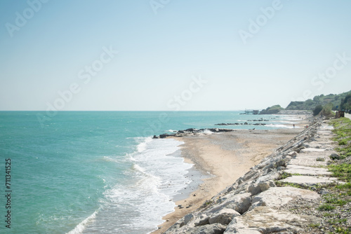 View of a turquoise water beach against sky