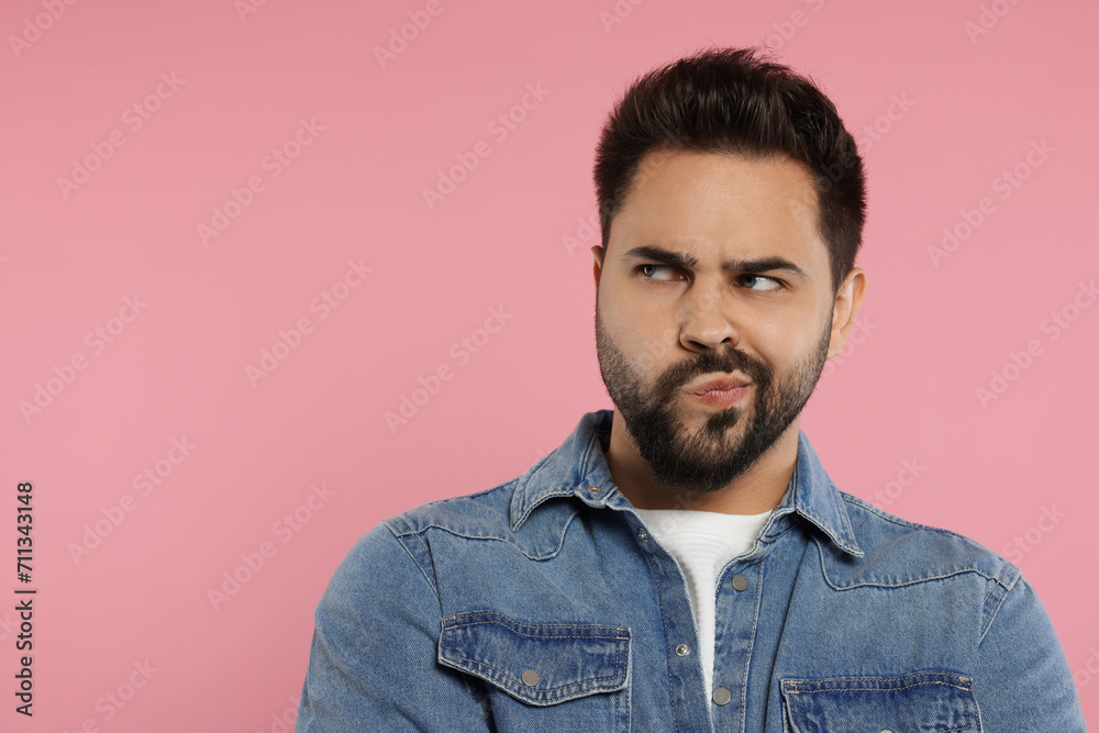 Resentful man on pink background. Space for text Resentful man on pink background. Space for text