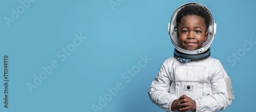American african child boy in a spacesuit like the cosmonaut isolated on blue banner background, conceptual of imagination and dream career, generative AI