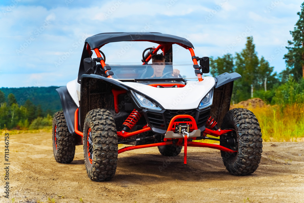 UTV, ATV rides off-road on sand. Extreme buggy driving