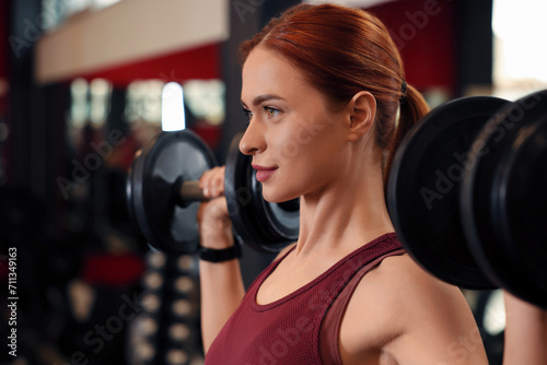 Athletic young woman with barbell training in gym, space for text © New Africa