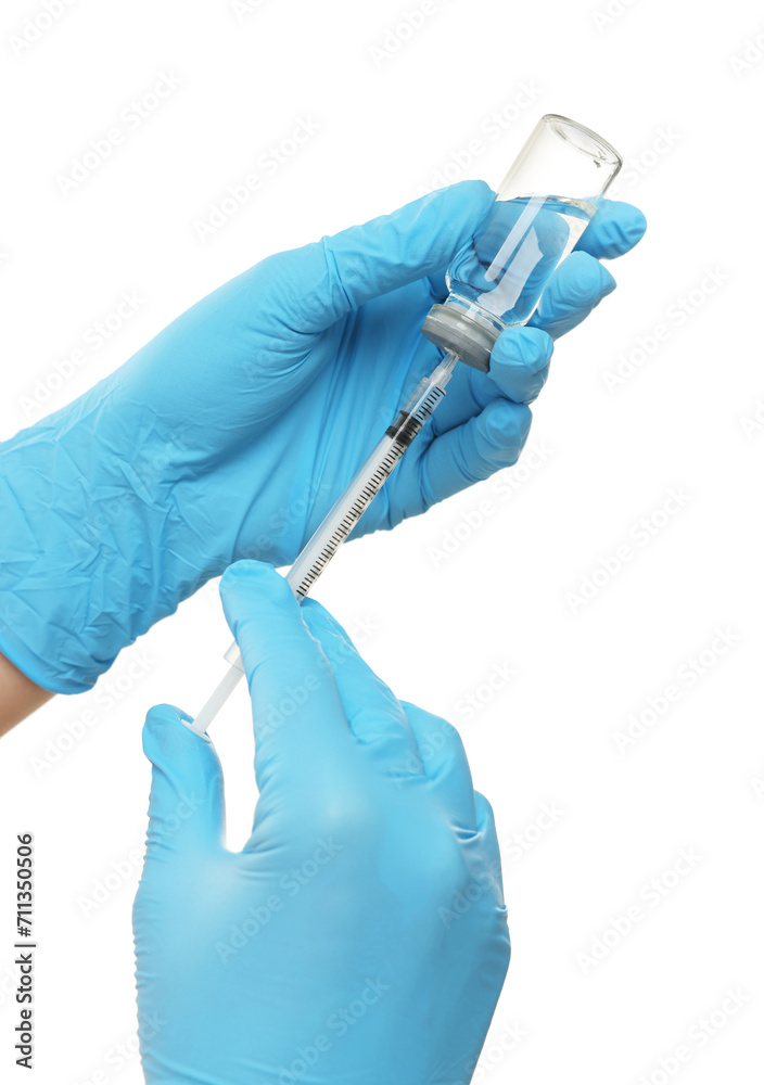 Doctor filling syringe with medication from glass vial on white background, closeup