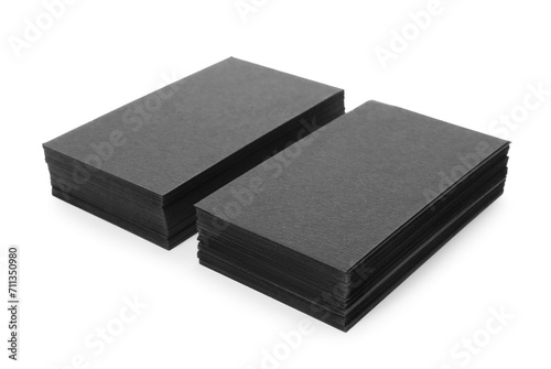 Stacks of blank black business cards isolated on white. Mockup for design