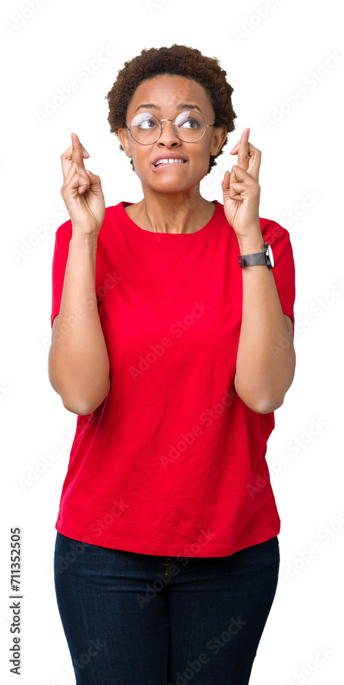 Beautiful young african american woman wearing glasses over isolated background smiling crossing fingers with hope and eyes closed. Luck and superstitious concept. Beautiful young african american woman wearing glasses over isolated background smiling crossing fingers with hope and eyes closed. Luck and superstitious concept.