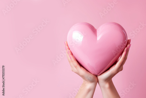 Gentle Gesture: Holding a Pink Heart on a Soft Pink Background