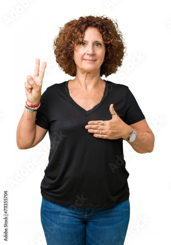 Beautiful middle ager senior woman over isolated background Swearing with hand on chest and fingers, making a loyalty promise oath