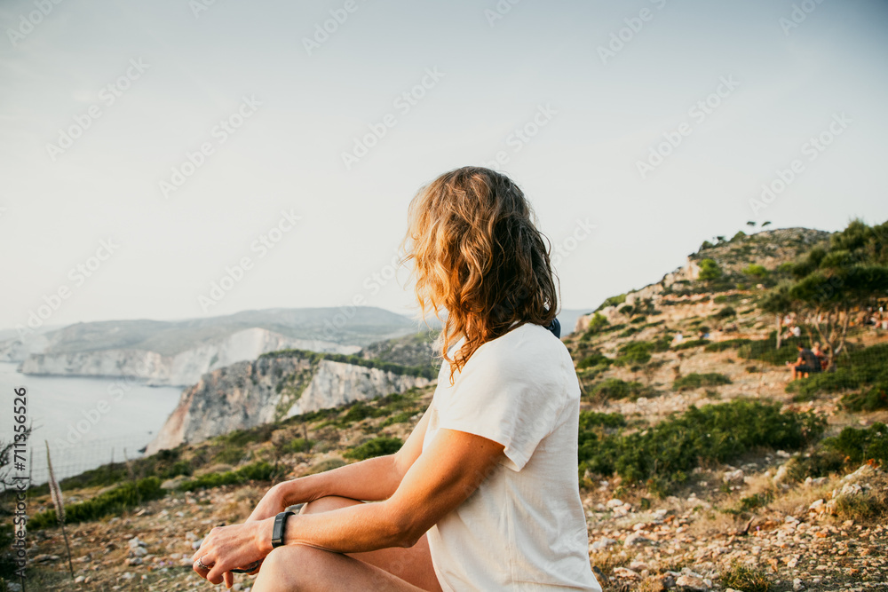 woman tourist relaxing and watching rocks in the sea