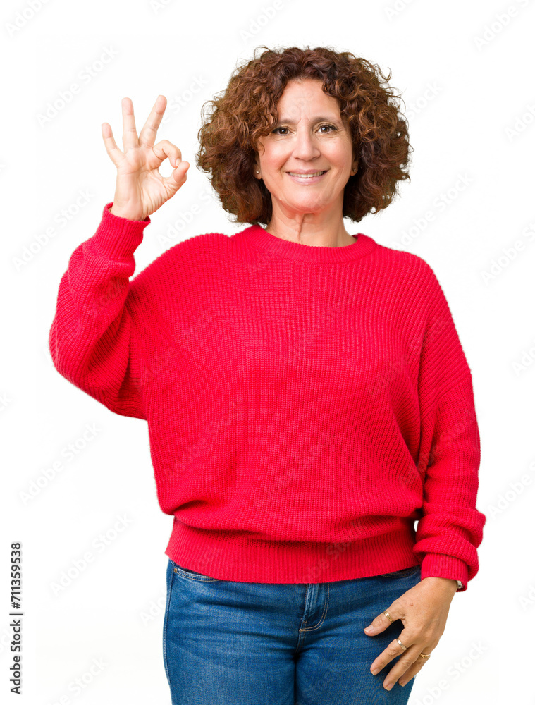 Beautiful middle ager senior woman red winter sweater over isolated background smiling positive doing ok sign with hand and fingers. Successful expression. Beautiful middle ager senior woman red winter sweater over isolated background smiling positive doing ok sign with hand and fingers. Successful expression.