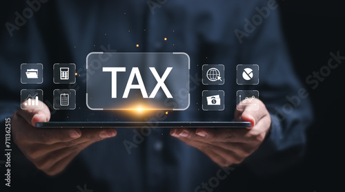 Businessman using tablet for calculates income to pay taxes to the government. Paying taxes. Filling online tax return form for payment. Calculation tax return taxes and VAT. Financial research.