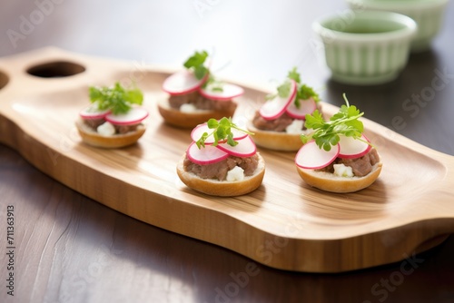 row of sopes with beef and radish on a rustic tray