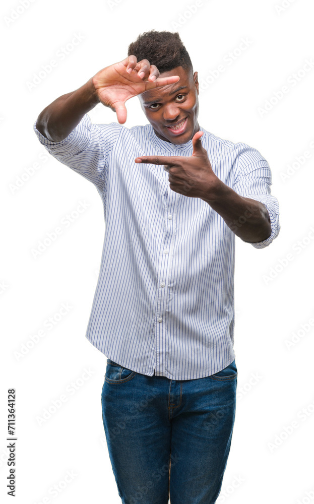 Young african american man over isolated background smiling making frame with hands and fingers with happy face. Creativity and photography concept. Young african american man over isolated background smiling making frame with hands and fingers with happy face. Creativity and photography concept.