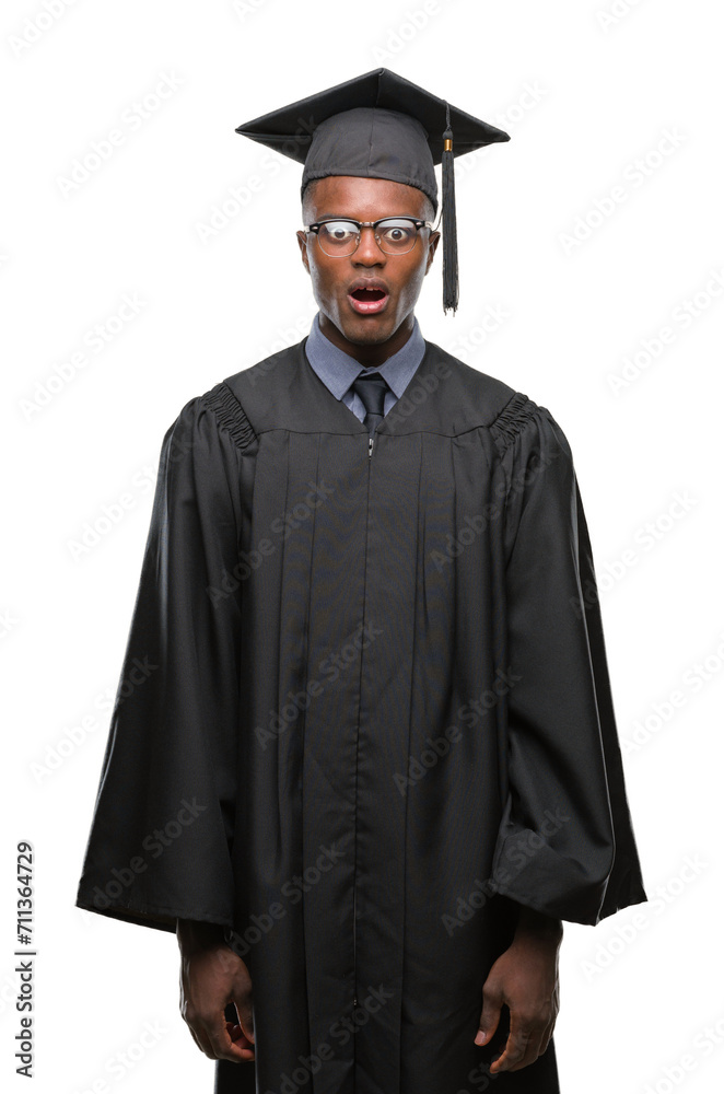 Young graduated african american man over isolated background afraid and shocked with surprise expression, fear and excited face. Young graduated african american man over isolated background afraid and shocked with surprise expression, fear and excited face.