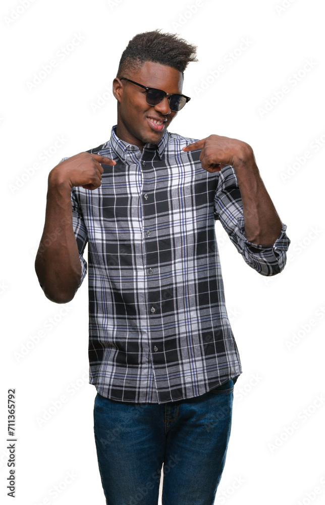 Young african american man wearing sunglasses over isolated background looking confident with smile on face, pointing oneself with fingers proud and happy. Young african american man wearing sunglasses over isolated background looking confident with smile on face, pointing oneself with fingers proud and happy.