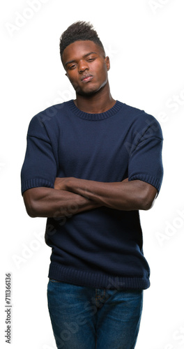 Young african american man over isolated background skeptic and nervous, disapproving expression on face with crossed arms. Negative person. © Krakenimages.com