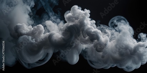 A voluminous long cloud of smoke in the dark. photo