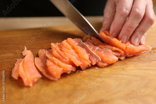 Cut the salmon into pieces with a knife. Cooking dishes from red fish