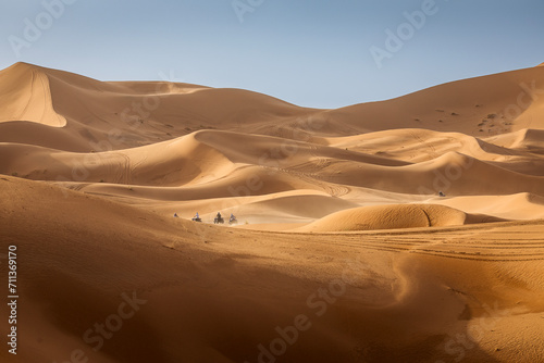 ATV machine running on desert dunes in Sahara, Merzouga, Morocco