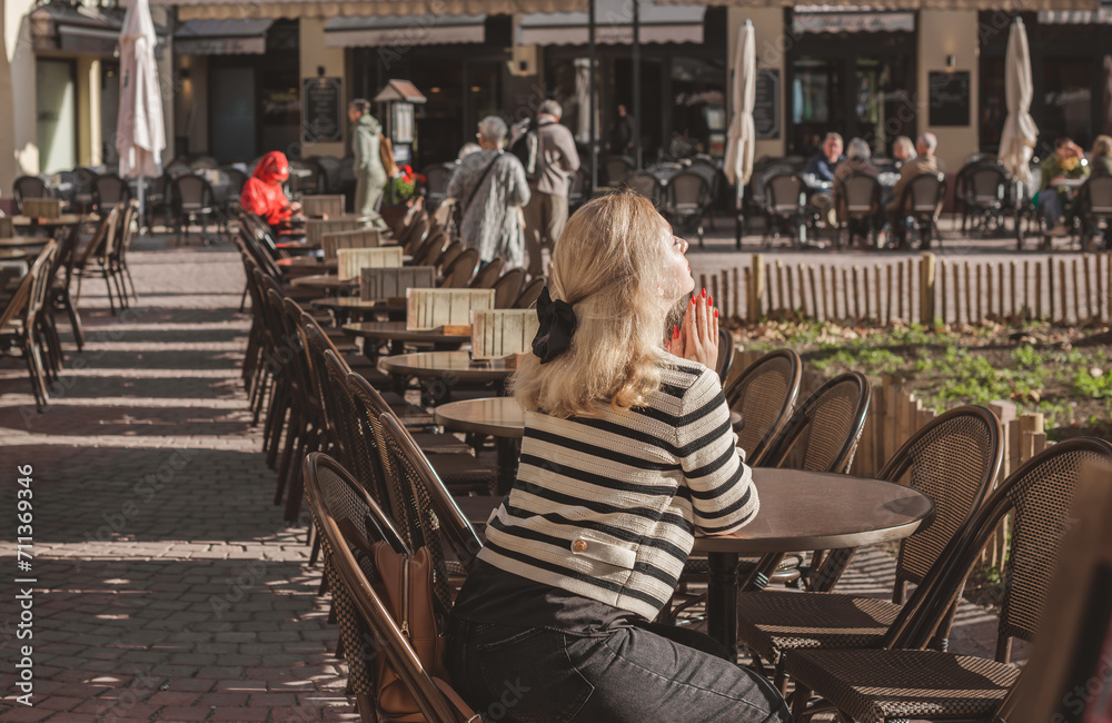 Fototapeta premium Vacation in France. Concept of tourism and holidays. Woman in city scene